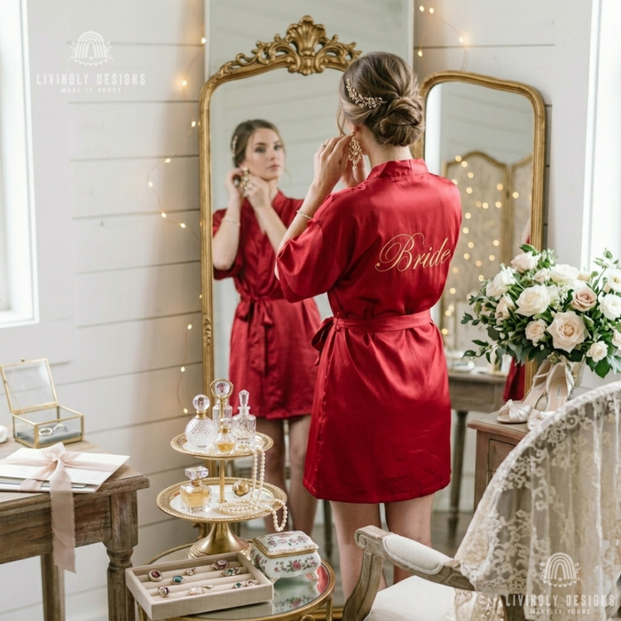 Back of woman wearing red bridal gown with 'Bride' on the back
