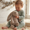 Child holding a bunny plush named Liam.
