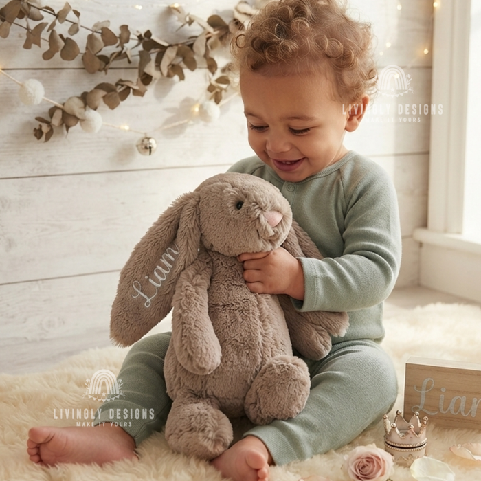 Child holding a bunny plush named Liam.