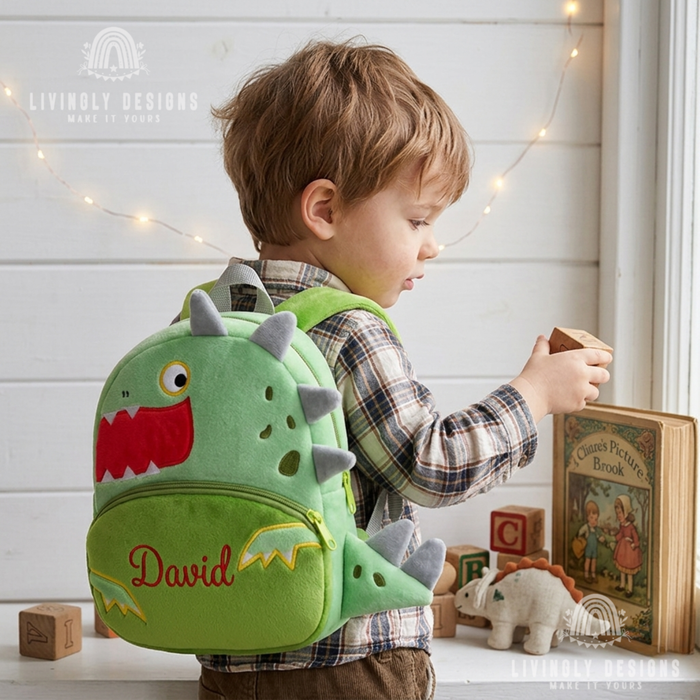 Child wearing a green dinosaur-shaped backpack named David.
