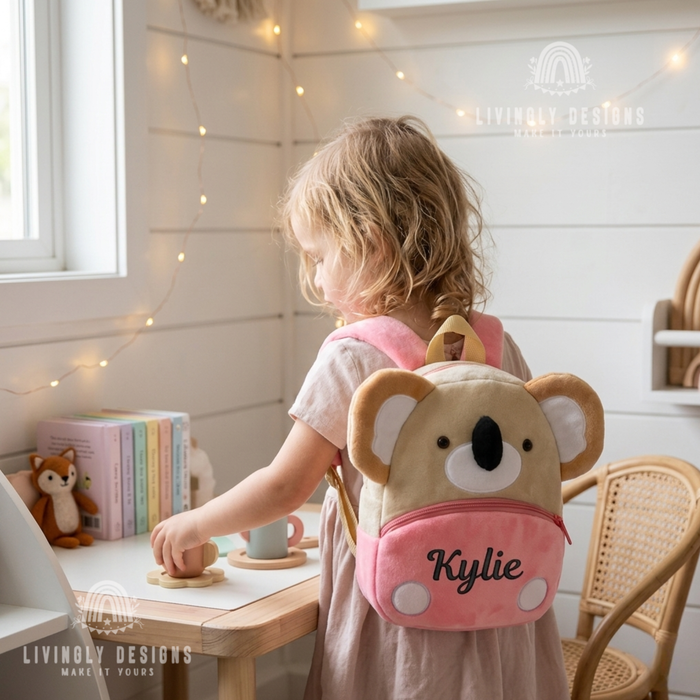 Child wearing a pink koala-shaped backpack named Kylie.