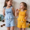 Girls wearing blue and yellow ribbed tank sets named Yara and Tessa
