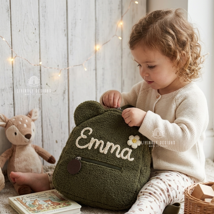 Child unzipping a green teddy bear backpack named Emma.