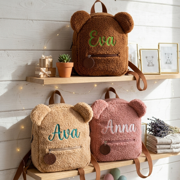 Brown, tan, and pink teddy bear backpacks named Eva, Ava, and Anna.
