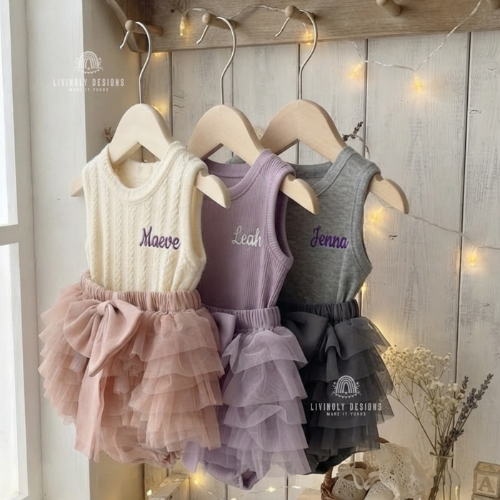 Cream, purple, and gray tank-top rompers with ruffled tutu bottoms, personalized with the names "Maeve," "Leah," and "Jenna"