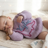 Lavender sweater named Kylie on sleeping baby.