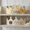 Two fabric crowns, yellow and cream, named Zara and Amy.