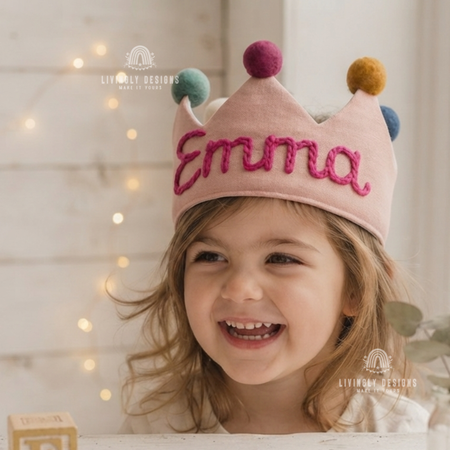 Girl wearing a pink fabric crown named Emma.