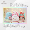 Promotional graphic showcasing personalized plush backpacks a blue penguin embroidered with Zoey, a pink bunny embroidered with Daisy, and a doll character embroidered with Zara highlighting customized options and quality embroidery.