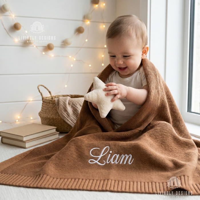 Baby wrapped in a brown personalized blanket named Liam, holding a plush star toy.