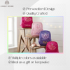 Four backpacks in pink, light pink, purple, and hot pink with sparkly tulle ballerina dress appliqués, personalized with the names "Valerie," "Mia," "Kylie," and "Jenna," displayed on a wooden ladder