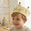 Boy wearing a yellow fabric crown named Oliver.
