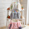 Cream, grey, and pink bunny Easter baskets personalized with names Mila, Isla, and Linda