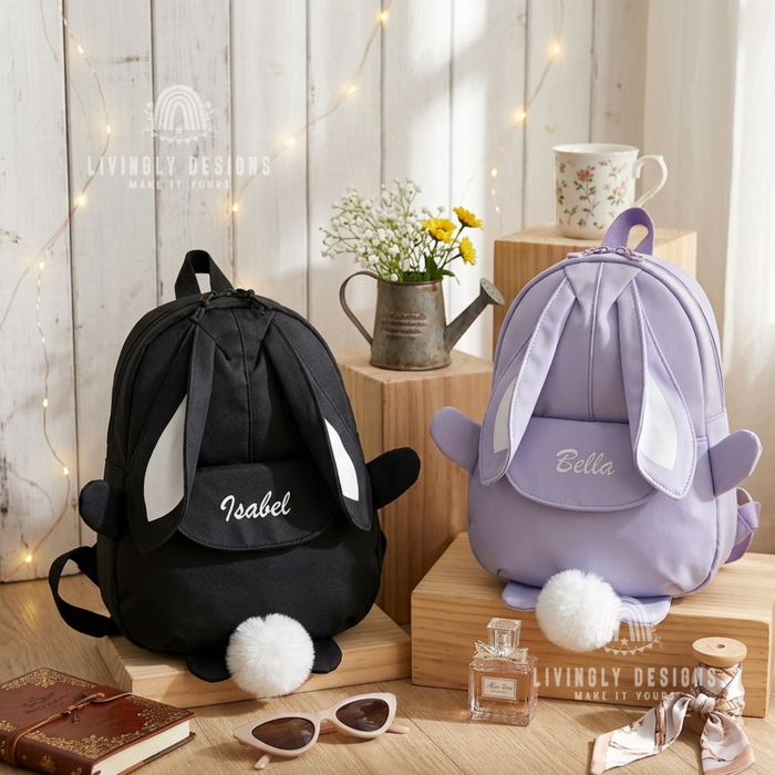 Black and purple bunny backpacks with the names "Isabel" and "Bella"

