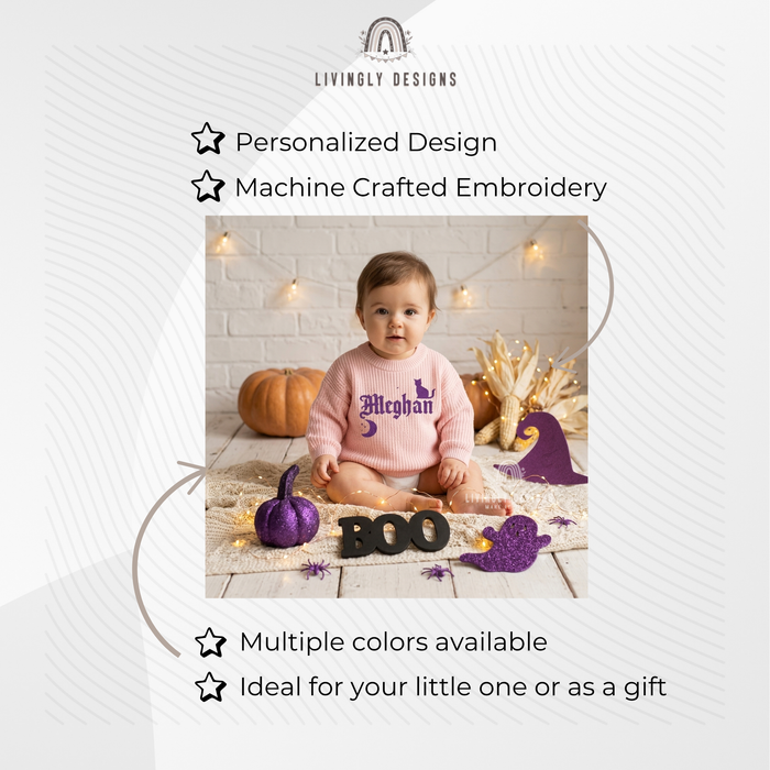 Baby wearing a pink knitted sweater personalized with the name "Meghan" and a black cat design, sitting among Halloween decorations