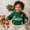 Smiling child wearing a green knitted Christmas sweater personalized with the name “Lucia” 