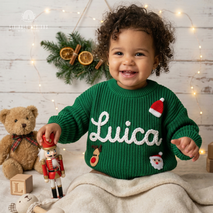 Smiling child wearing a green knitted Christmas sweater personalized with the name “Lucia” 