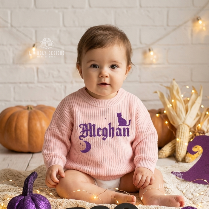 Baby wearing a pink knitted sweater personalized with the name "Meghan" in purple gothic-style lettering
