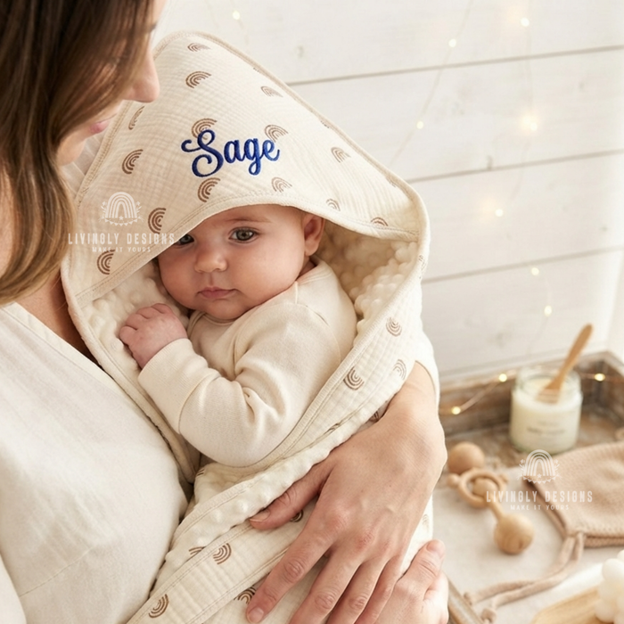 Cream hooded towel named Sage, baby wrapped in mother's arms.