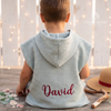 Back view of a child wearing a sage green hooded waffle bathrobe custom embroidered with the name David.