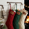 Red, green, and cream knit stockings with leather patches for "Sienna," "Sage," and "Silas"
