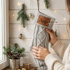 Gray knit stocking with a leather patch for "Nora"