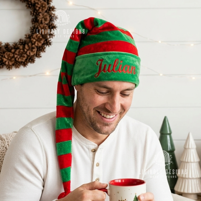 Man wearing a green and red striped elf hat with the name "Julian"