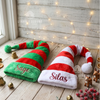 Green and red striped elf hats with the names "Sage" and "Silas"