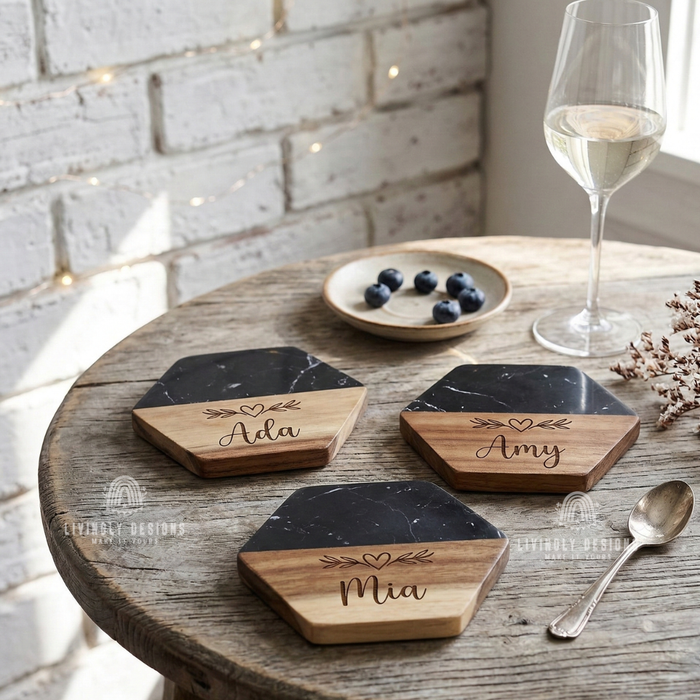 Three hexagonal marble and wood coasters engraved with the names "Ada," "Amy," and "Mia"