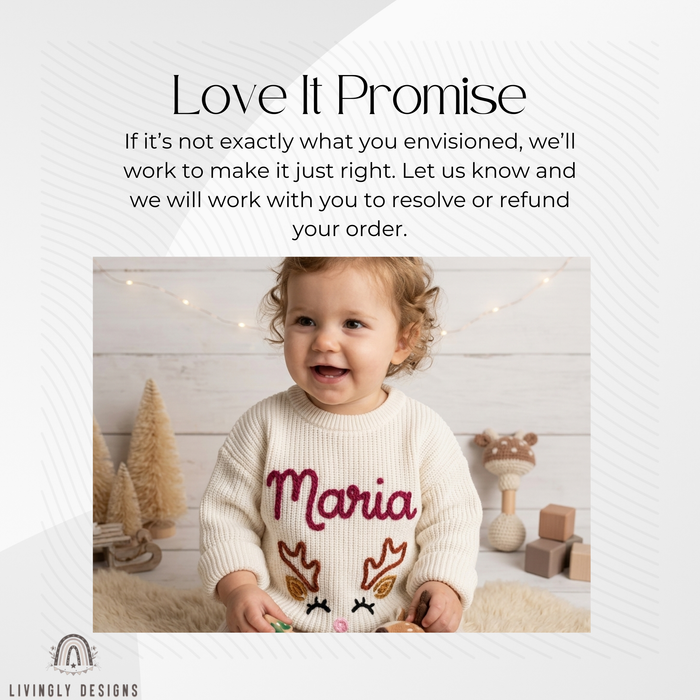 Smiling toddler girl wearing a cream knitted sweater personalized with the name "Maria" and an embroidered reindeer face design, surrounded by holiday decor.