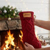 Red knit stocking with a riveted leather patch for "James"
