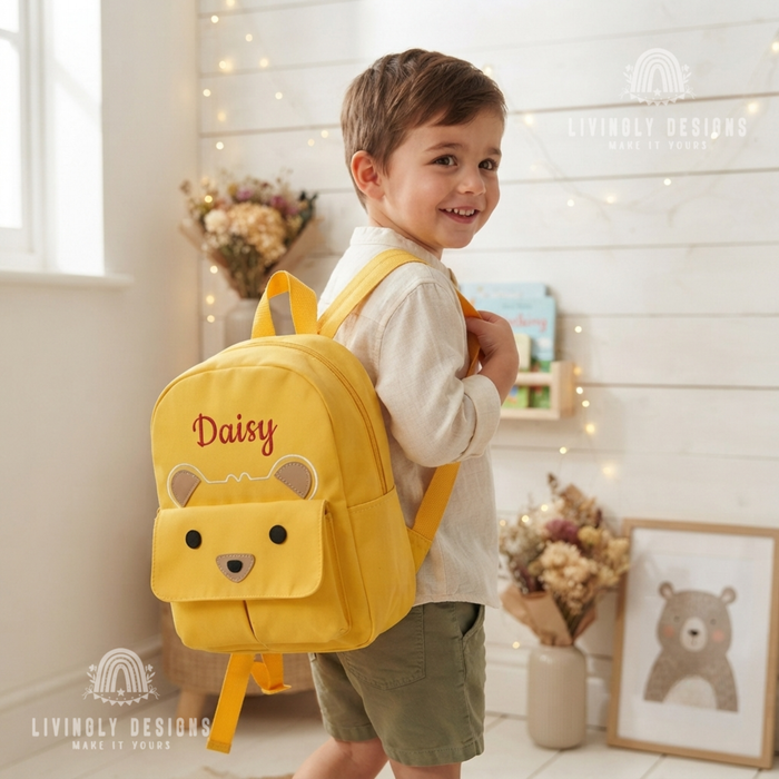 Boy wearing yellow bear backpack named Daisy