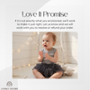 Smiling baby girl wearing a gray tank-top romper with a ruffled tutu bottom and bow, personalized with the name "Anna"