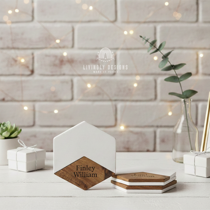 Hexagonal white marble and wood coasters engraved with the name "Finley William," displayed upright and stacked on a table
